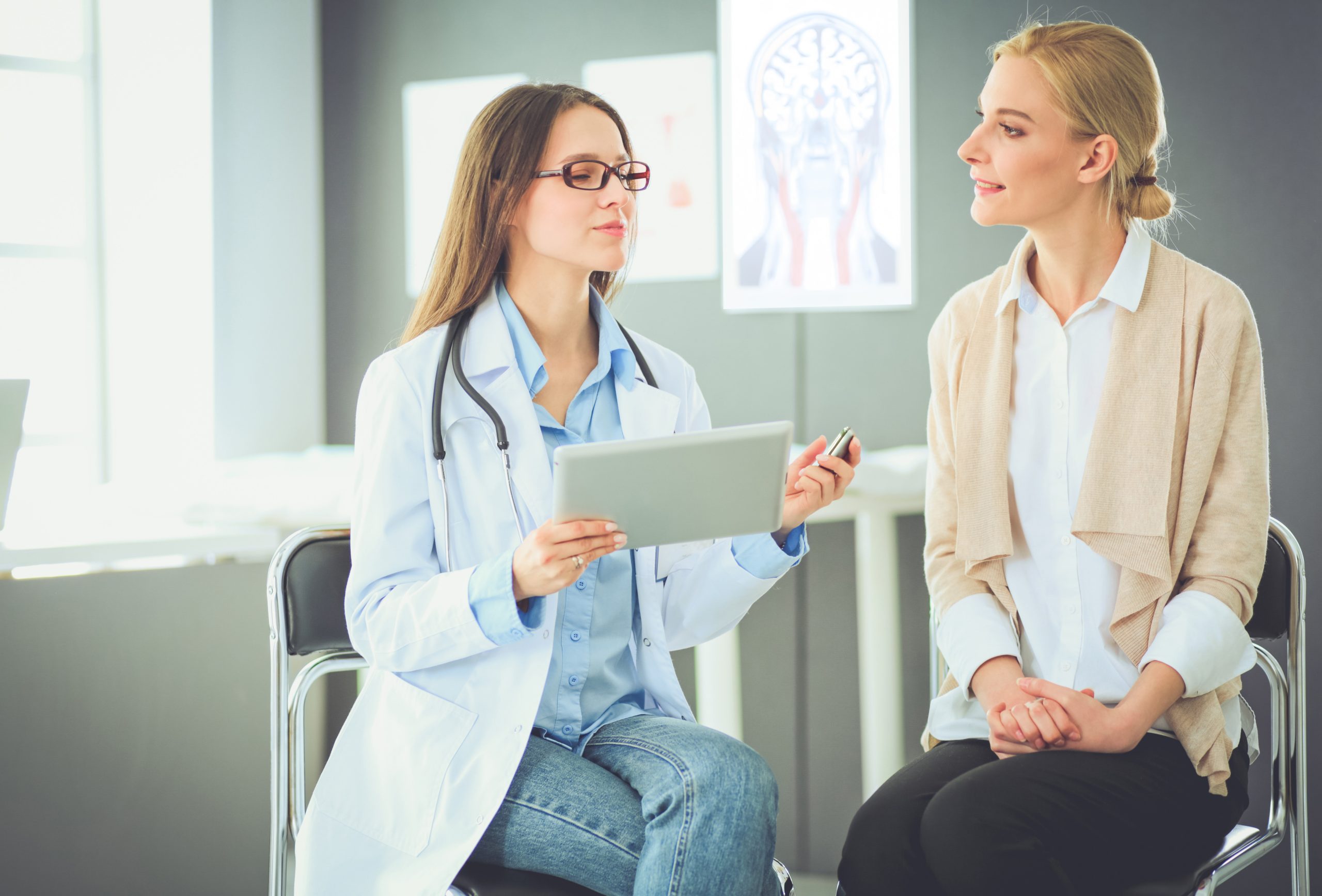 Doctor and patient discussing something while sitting at the table . Medicine and health care concept; Shutterstock ID 1105930313; Purchase Order: comps; Job: ; Client/Licensee: ; Other: