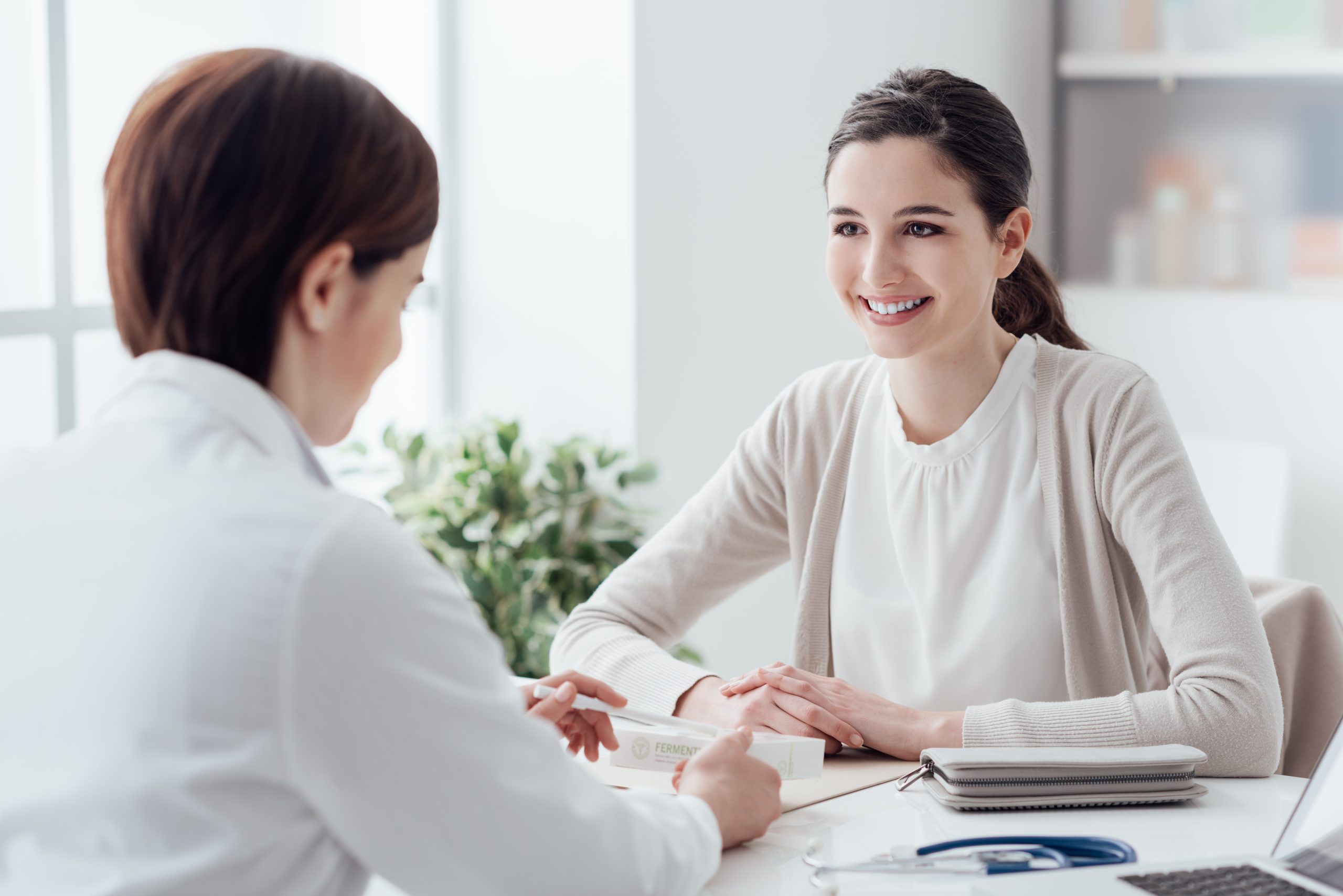 Smiling patient in the doctor's office, she is receiving a prescription medicine; Shutterstock ID 580164016; purchase_order: Limited 7/26/21